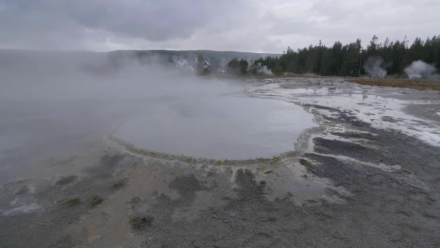 Steam rises off of a geyser