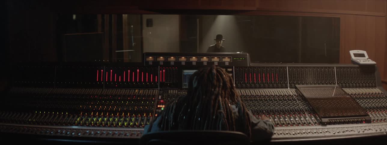 A music producer works at the studio