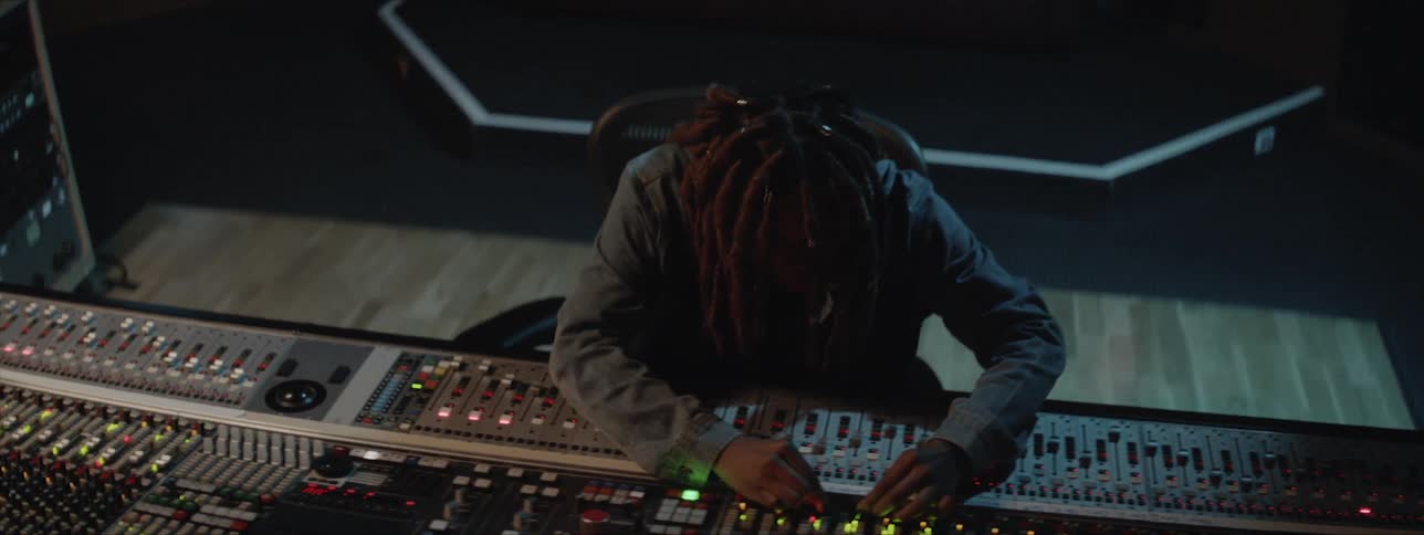 Woman adjusts the controls in a music studio