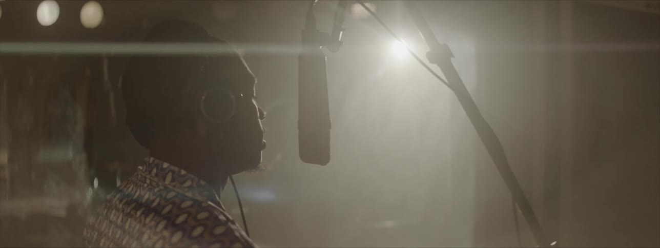 A man sings in to a microphone