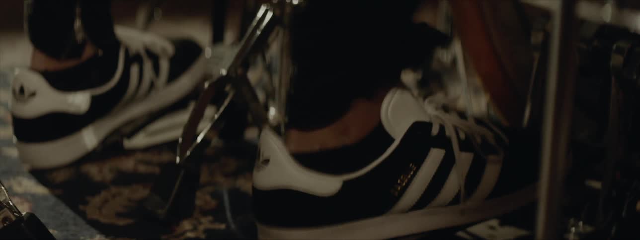 A person playing drums and using the drum pedal