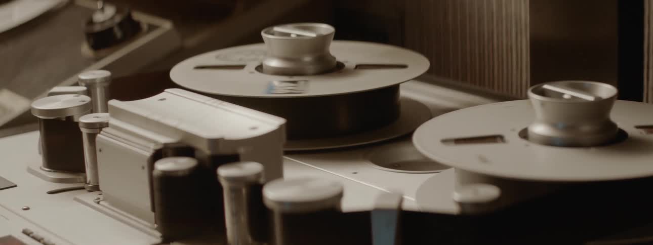 A large tape reel turning in a studio