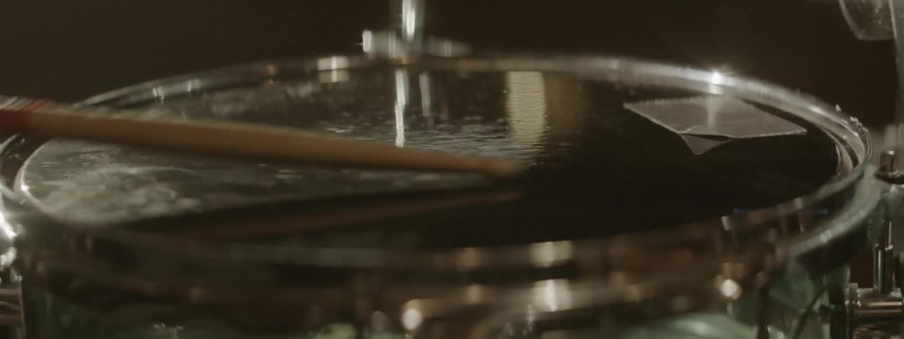 Close up of drumsticks hitting a snare drum
