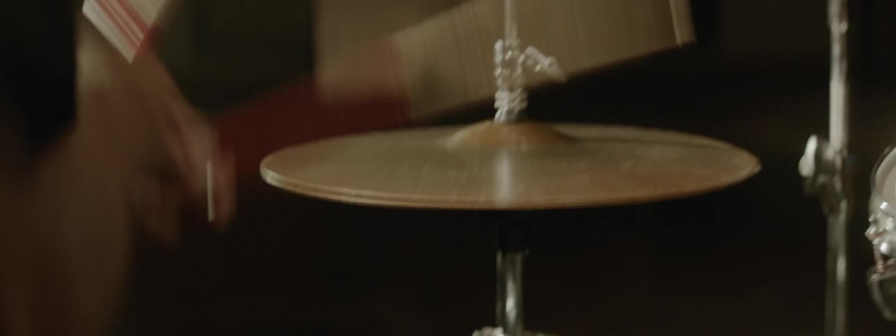 A drummer drums in a studio with a closed hi hat