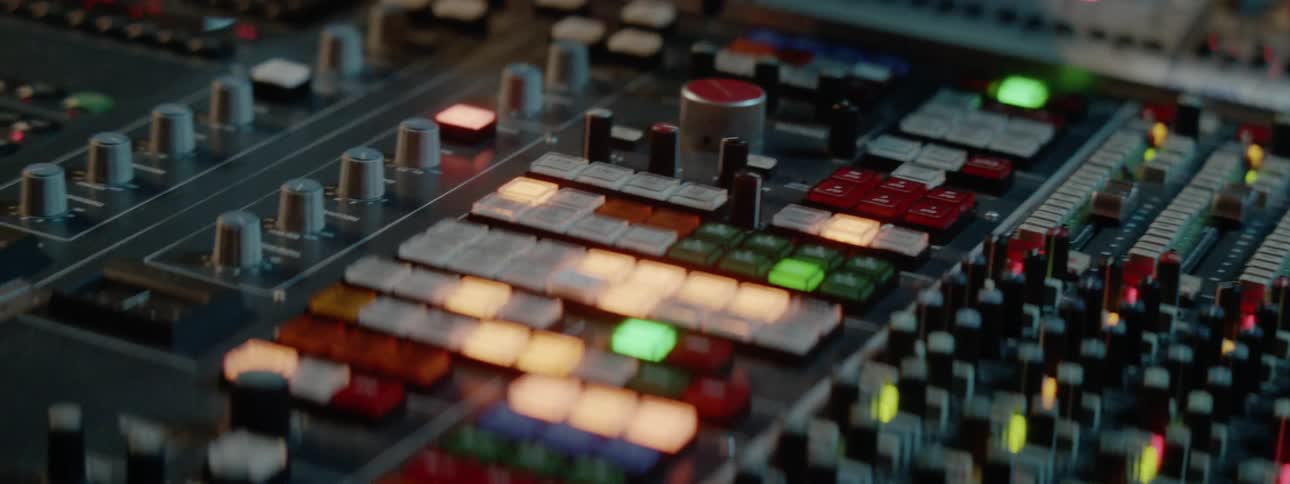 A person is turning the knob on the mixer