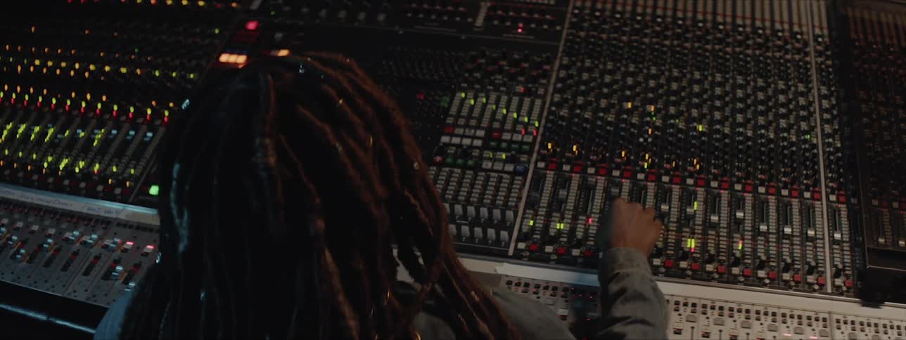 A young girl is pressing buttons on a sound board