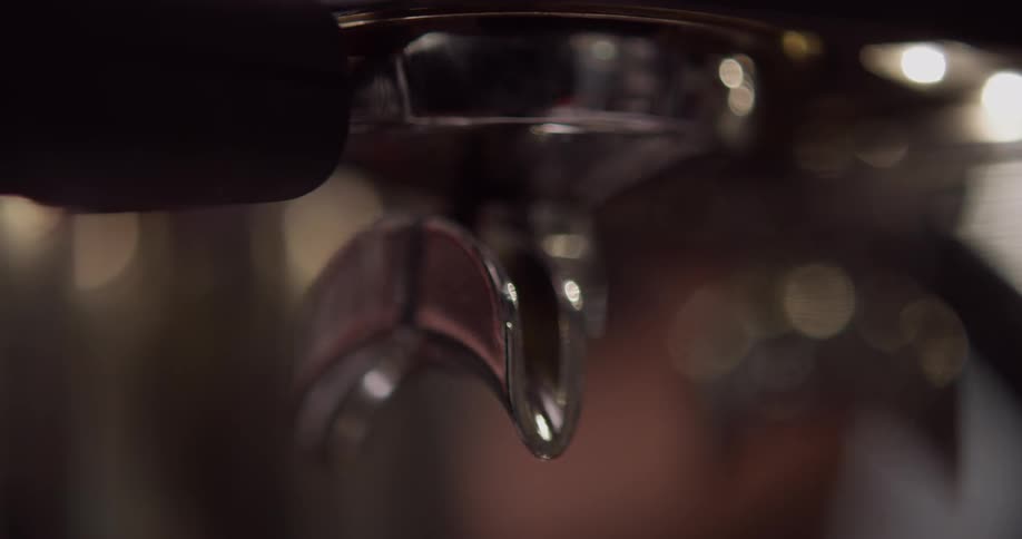 A person attaching a part to a coffee machine
