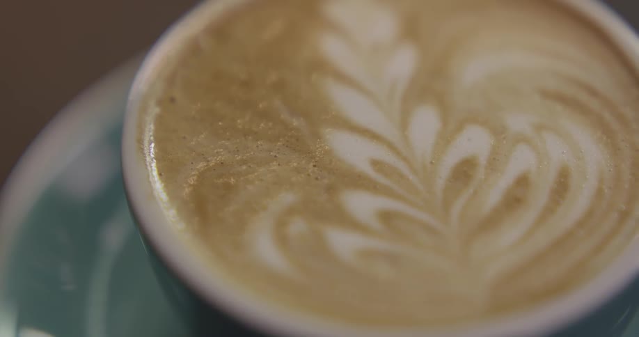 Latte art tulip in a white cup and saucer