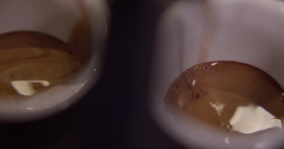 Coffee going in to a mugs