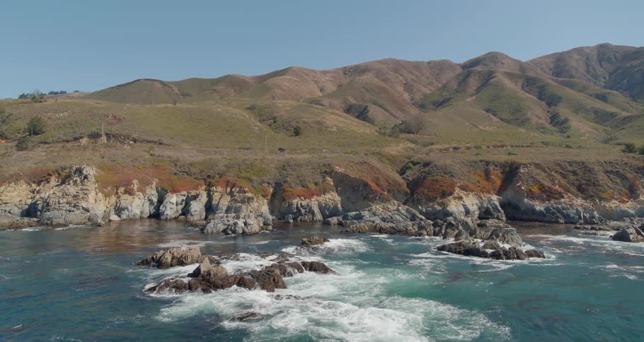 Birds eye view of waves crashing in to the rocks