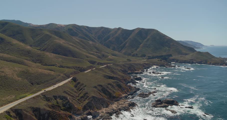 An aerial view of hill near ocean