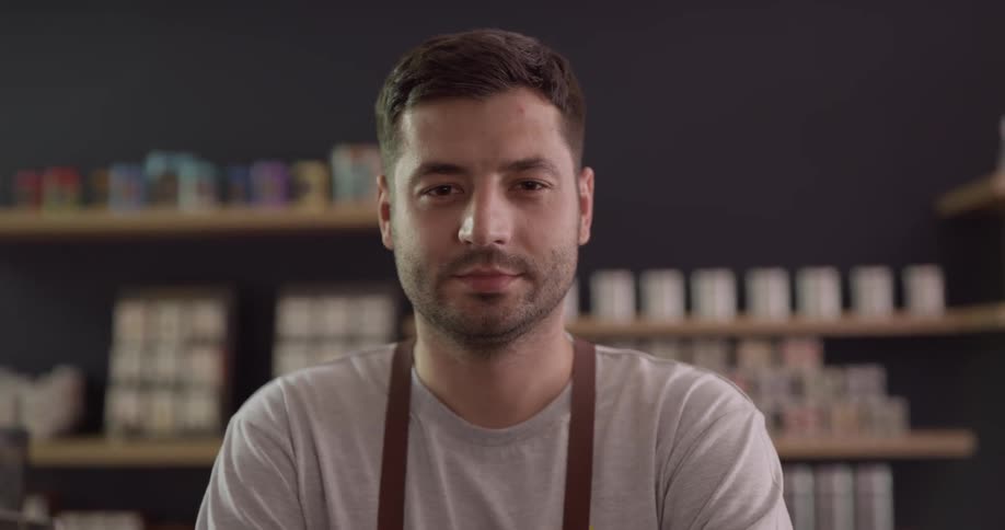 Man poses in front of shelves of product
