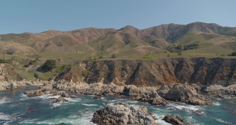 Waves crash against a rocky coastline