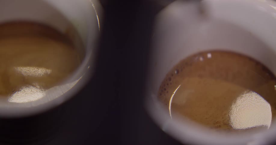 A few final drips of espresso drop into the two waiting espresso cups before they are taken away to be served