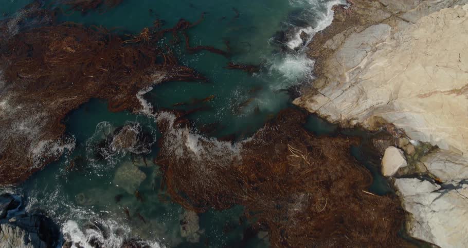 An aerial view of mountain and blue ocean