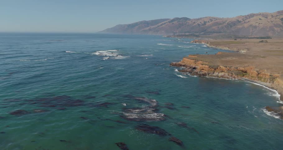 Coral reefs sit in shallow water off a coastline