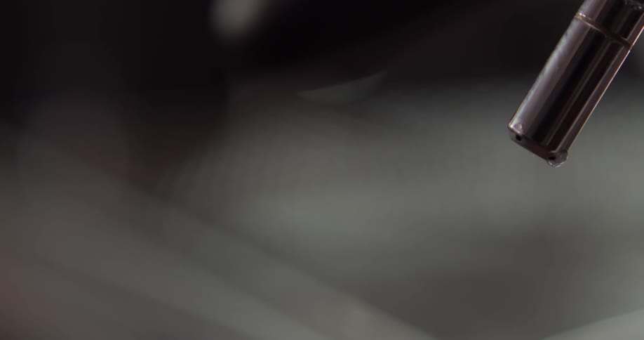 A nozzle spraying out mist and water