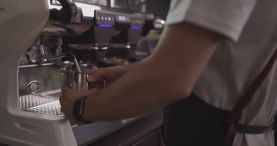 A bartender operating the drink machine