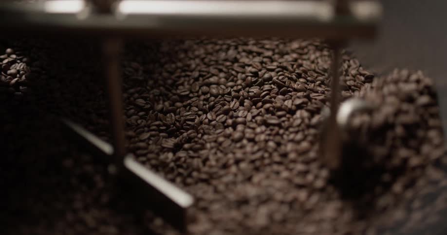 Coffee beans are being stirred by a stirring device