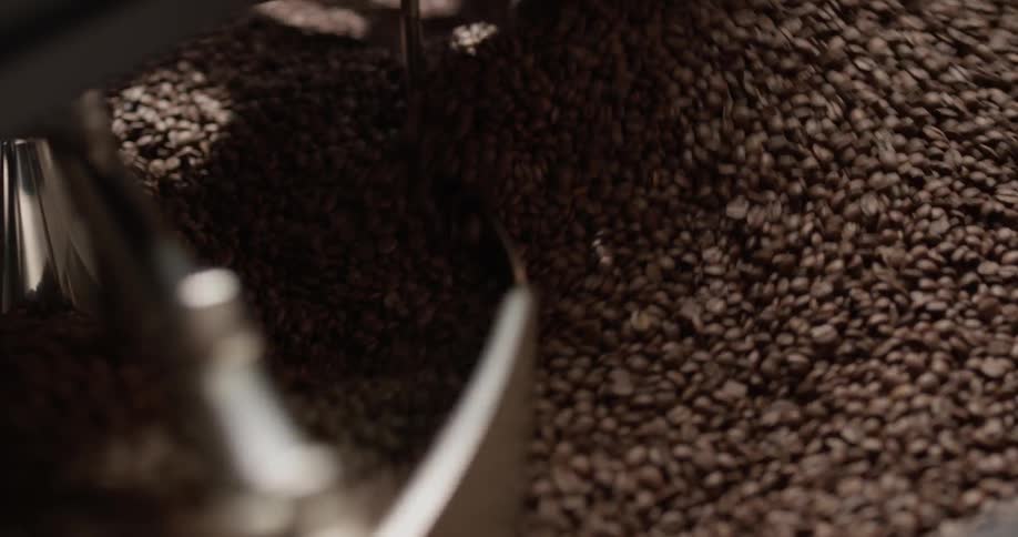 Coffee beans spinning in a roasting tray