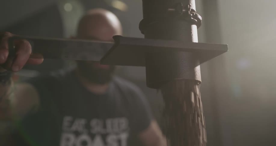 Man releases coffee beans from spout