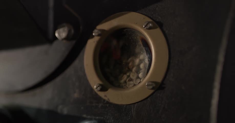 A small window reveals coffee beans grinding behind it