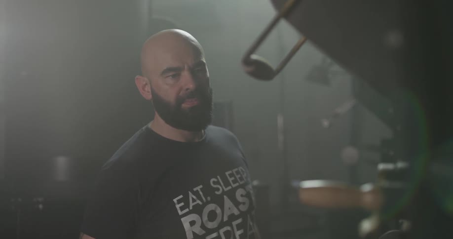 A man in a recording studio examines the equipment