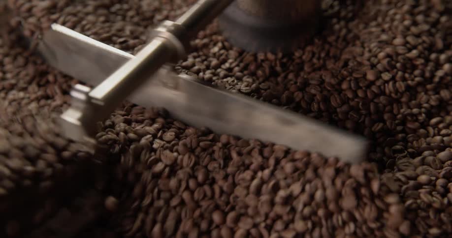 A machine is stirring coffee beans