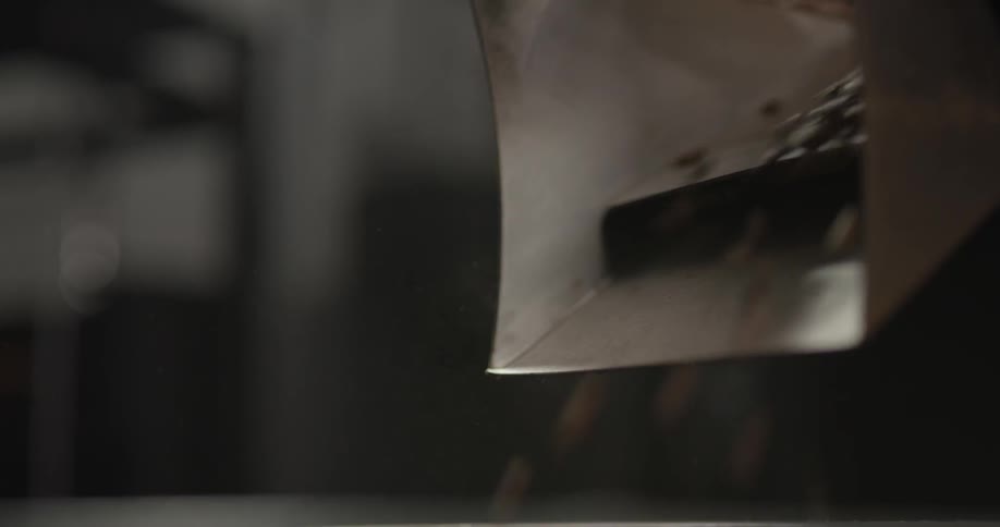 Person lifting a lever torelease coffee
