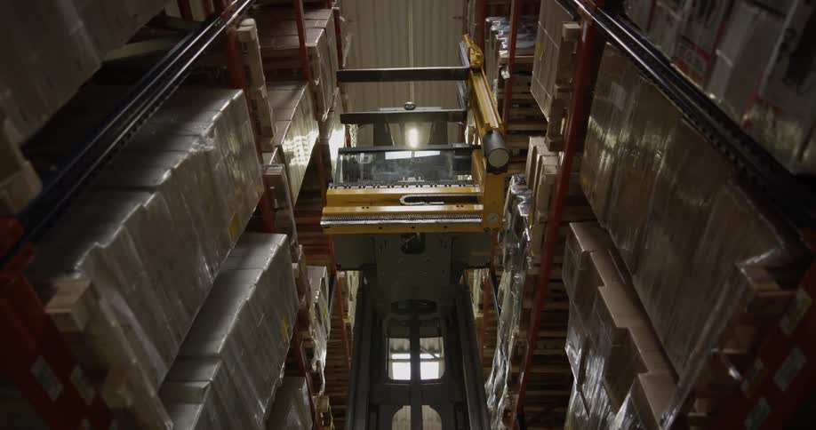 A forklift moves in an isle
