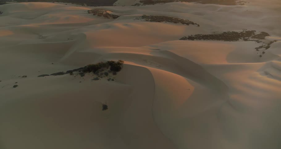 A snow covered rocky landscape at sunset