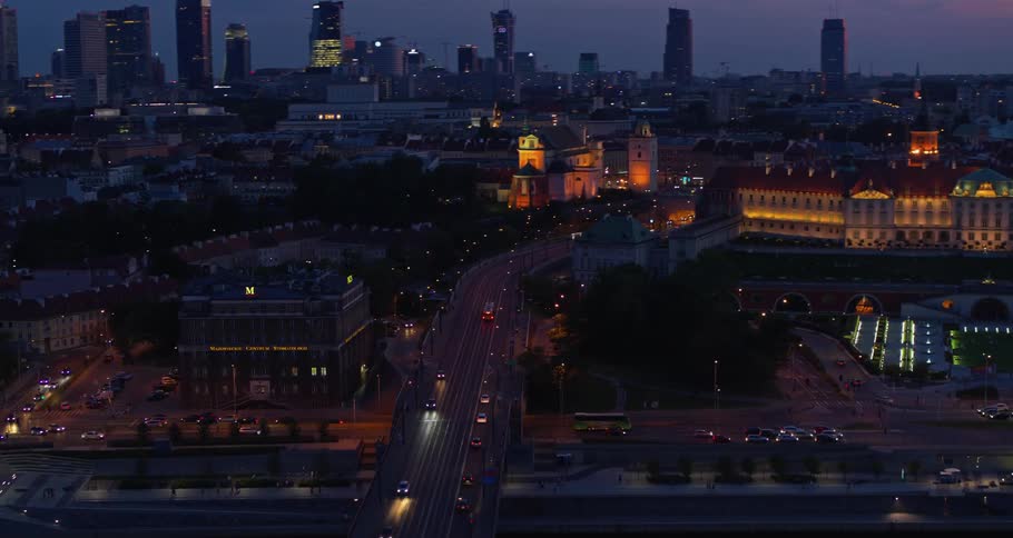Traffic moves through a large city at night