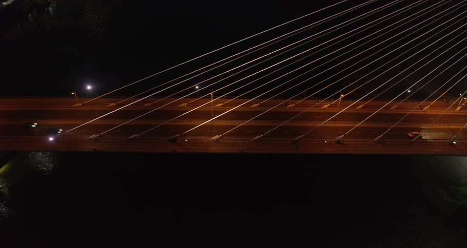 Birds eye view of cars driving across a bridge