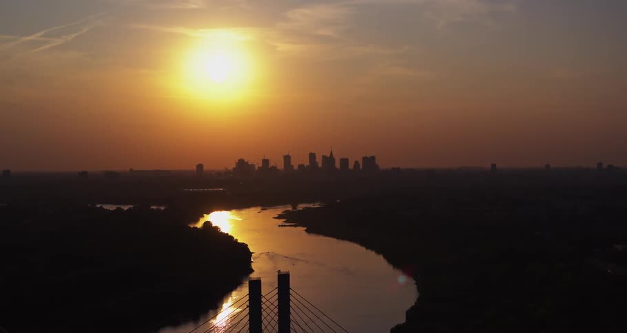 The sun starts to set over a city