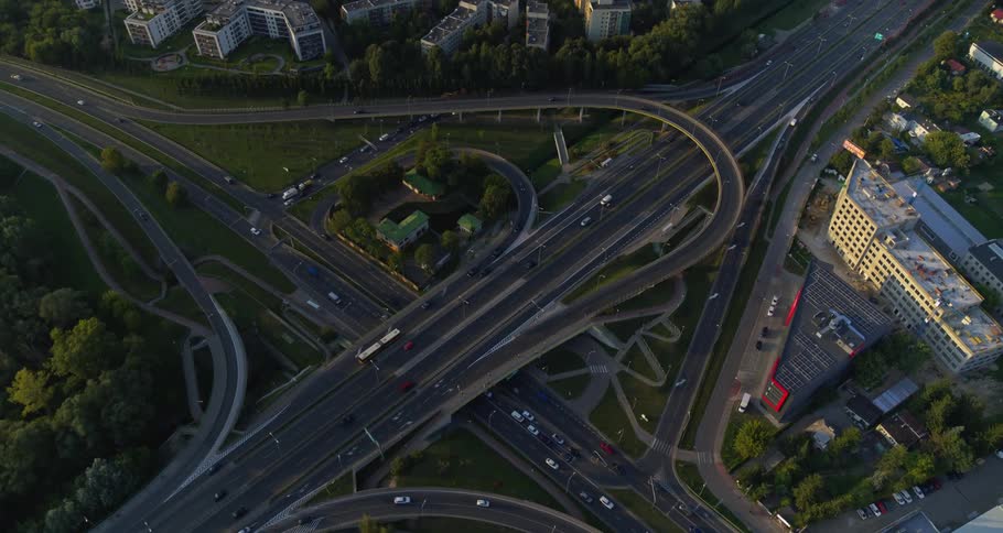 Vehicles travel a city highway intersection