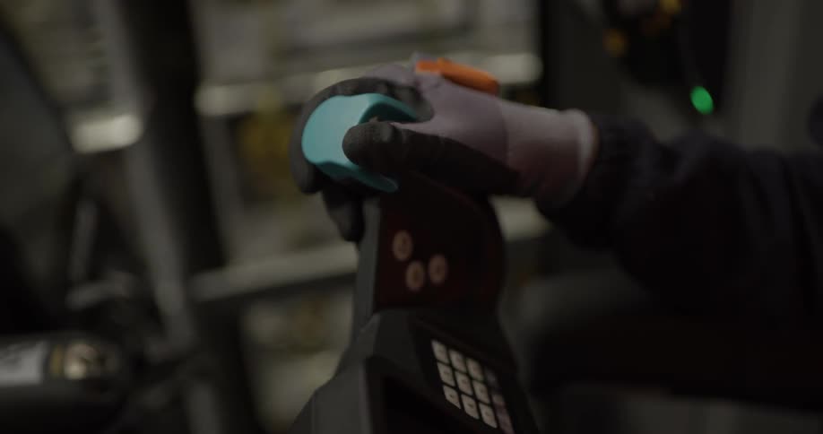 A person is driving a forklift in a warehouse