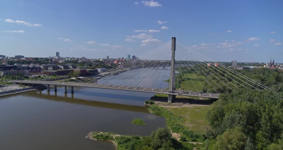 A bridge over a river with the city in the background