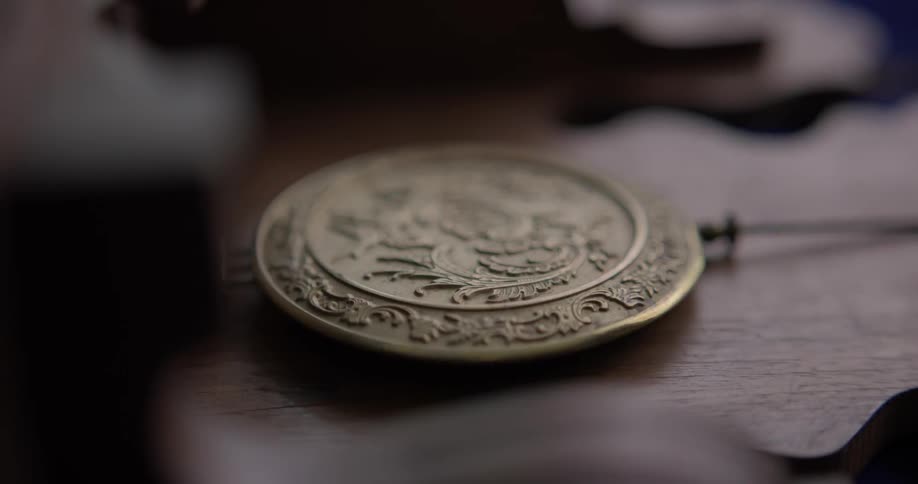 A person places a decorative piece on wood