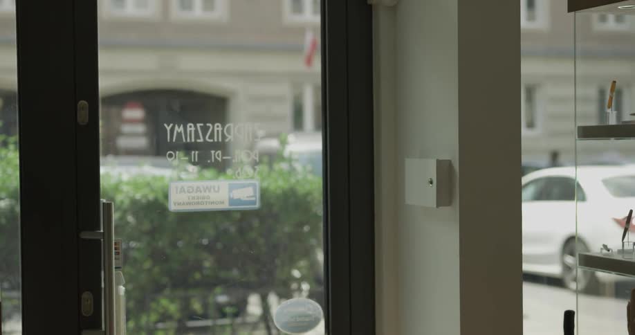 A man entering and exiting a glass door