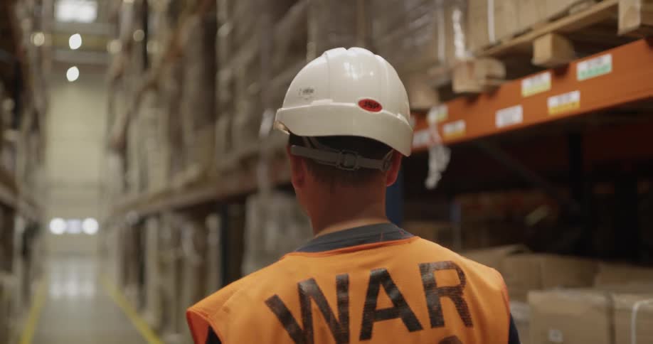 A man walks through the warehouse