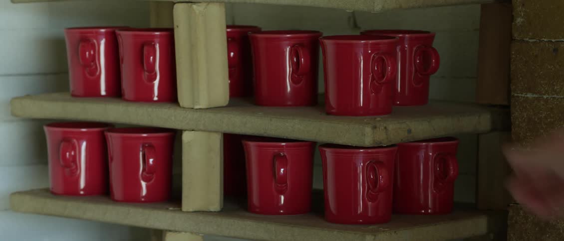Red coffee cups in a cupboard