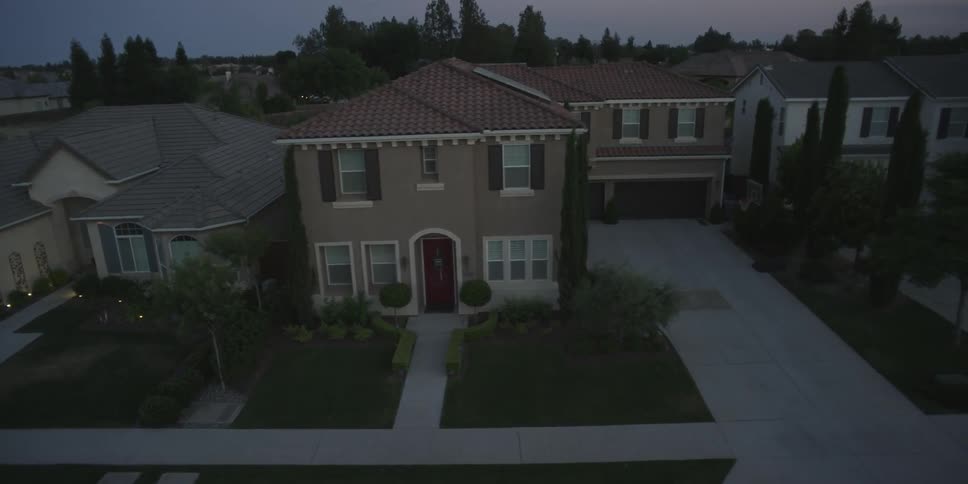Newer suburban houses are seen from above at dusk