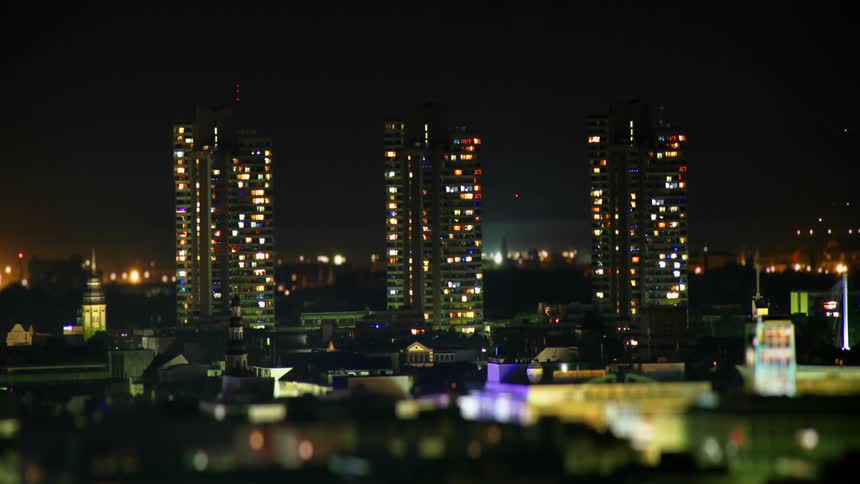 Lights change in tall buildings as the night passes