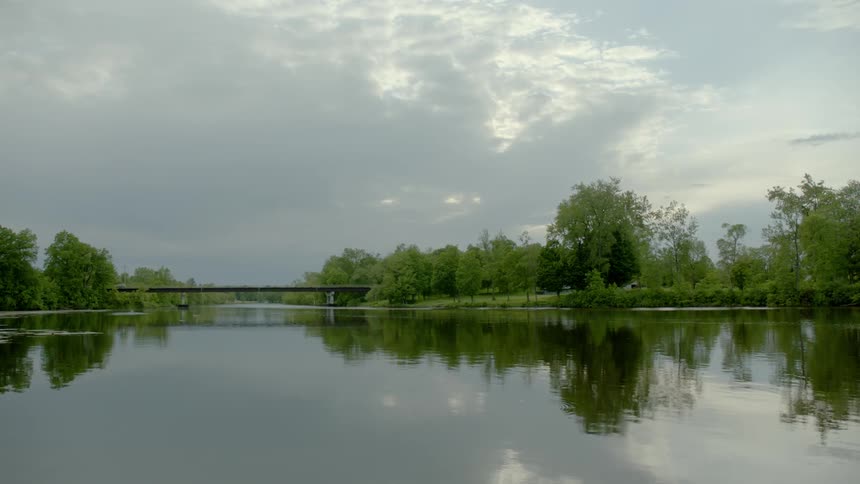 A calm lake reflecting the sky during the day