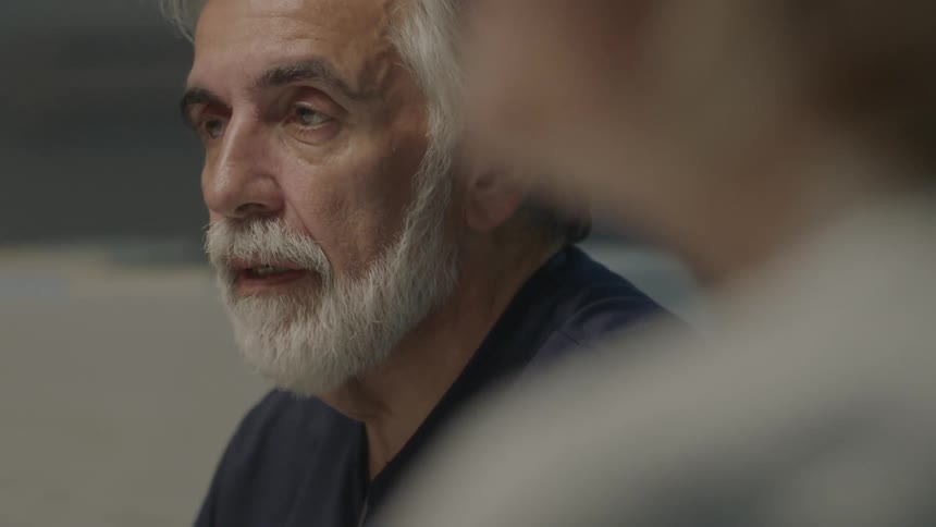 A man is talking with others in front of him