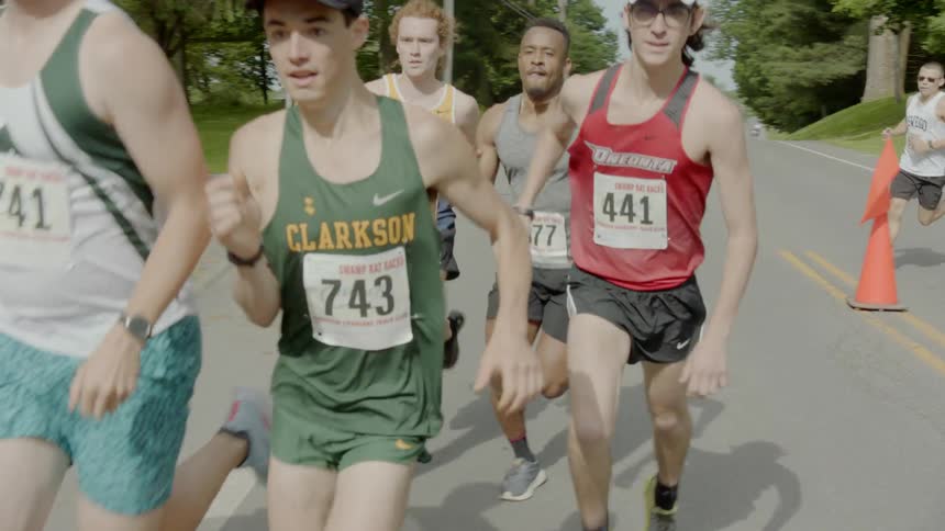 A group of male marathon runners turning onto another road