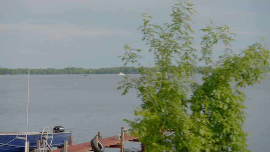 A coast line features docks boats and benches