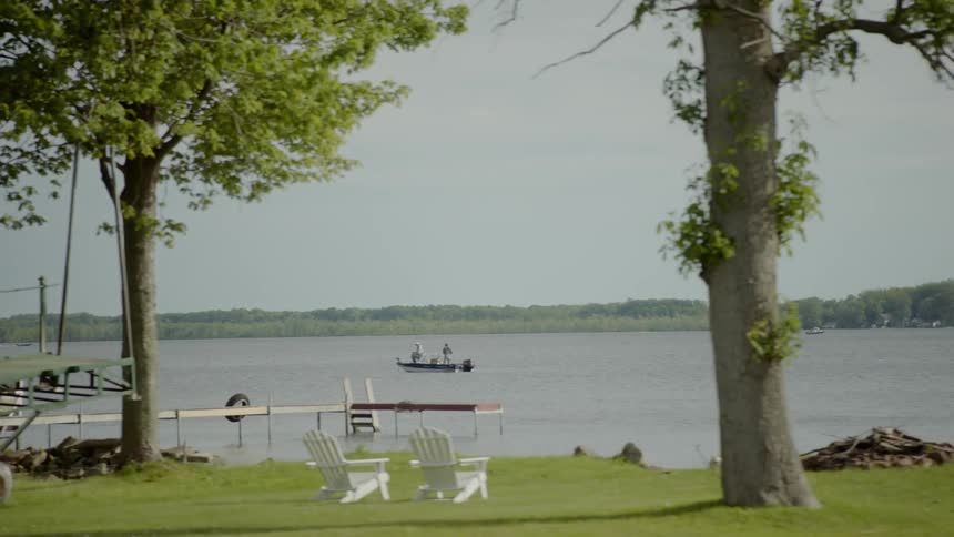 People engaging in recreation on and around a lake during the day