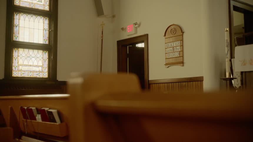 A window doors and a paschal candle in a church