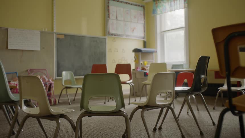 Chairs are in a circle inside a school room